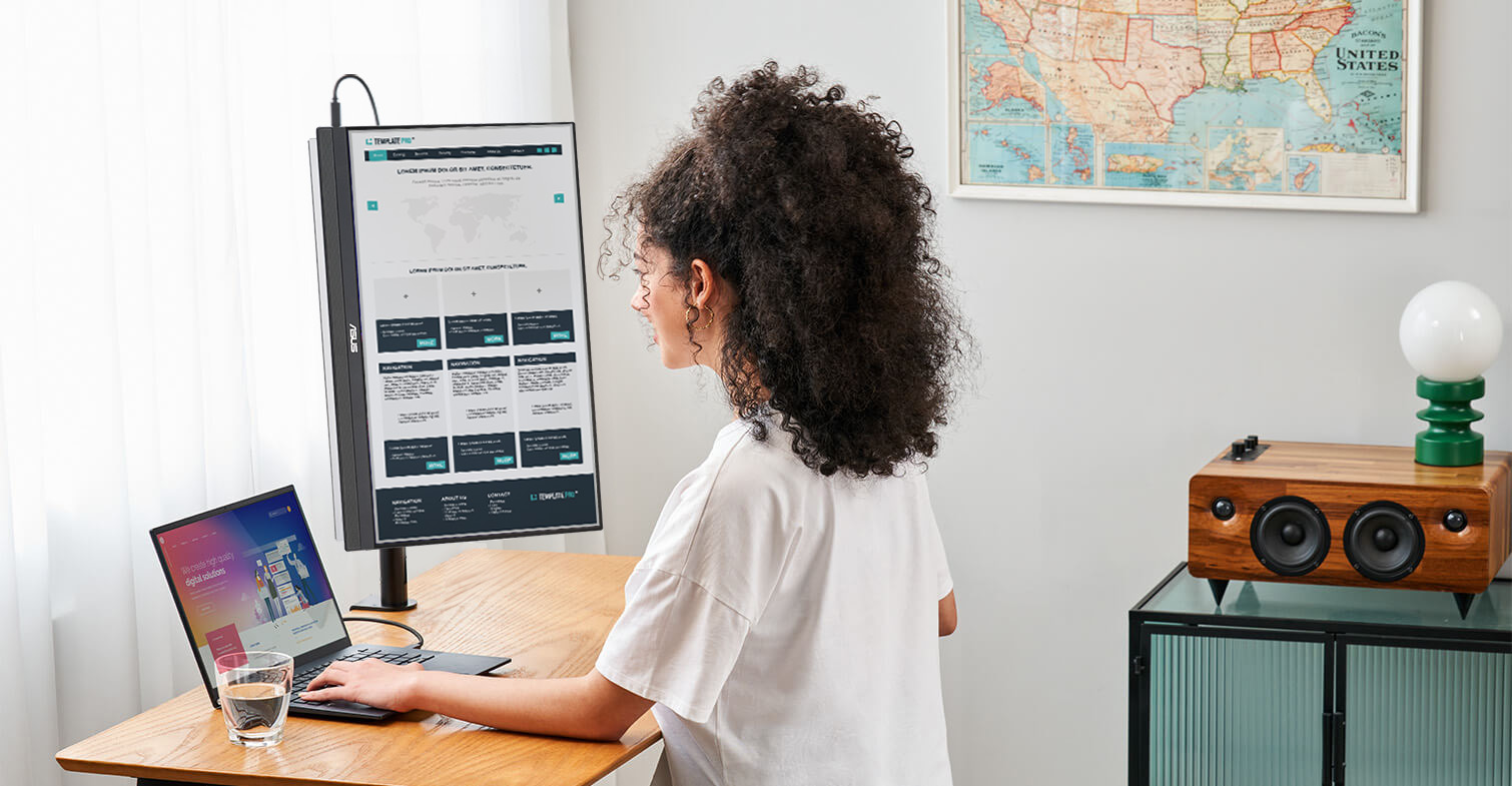 A woman works from home using ZenScreen MB229CF in portrait mode with C-clamp arm on small study table