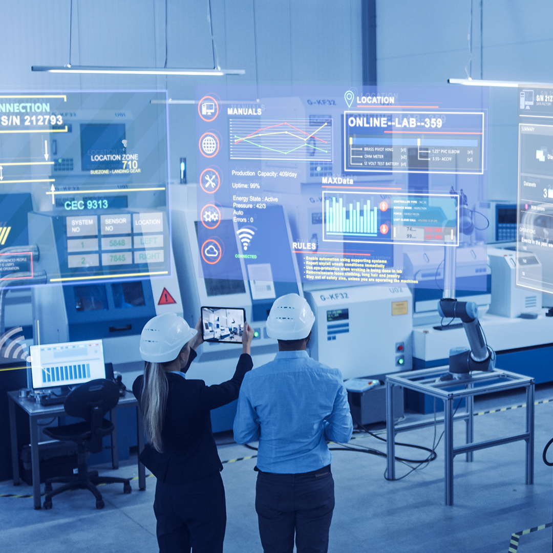 Engineers in AI-Powered smart factories Two engineers holding a tablet, monitoring AI-powered smart factories. The dashboards contain factory and machine information, and status, which are projected from the AR technology.